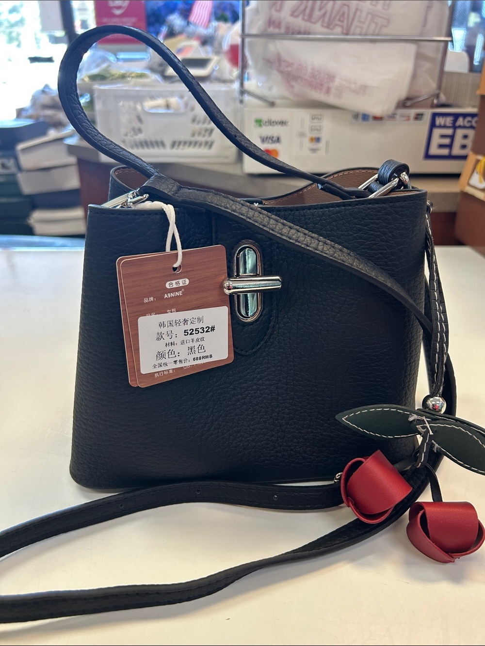 Black Pebble Leather Crossbody Bag with Rose Charm